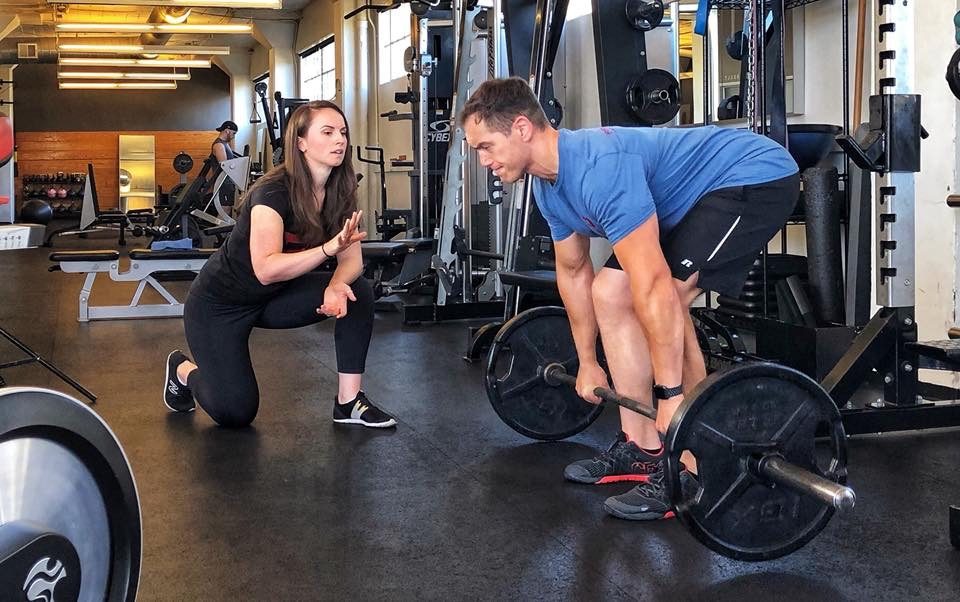 Fast Pace trainer coaching client on deadlift technique